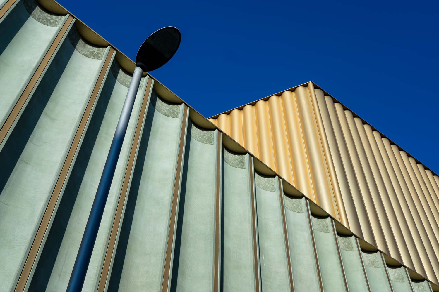 Abstract detail of the pleated green and gold facade of Nottingham Contemporary art gallery