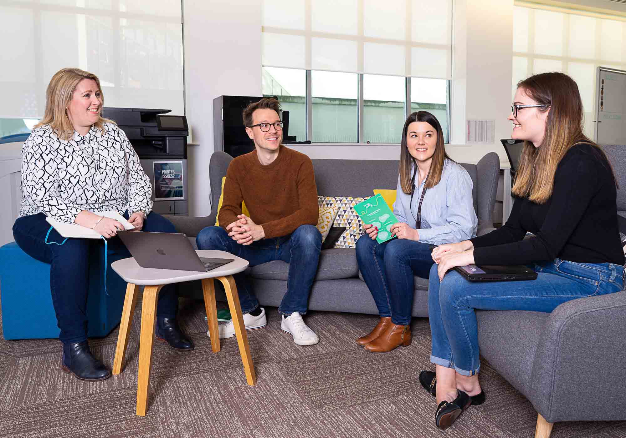 Openworks team in conversation during a corporate PR shoot