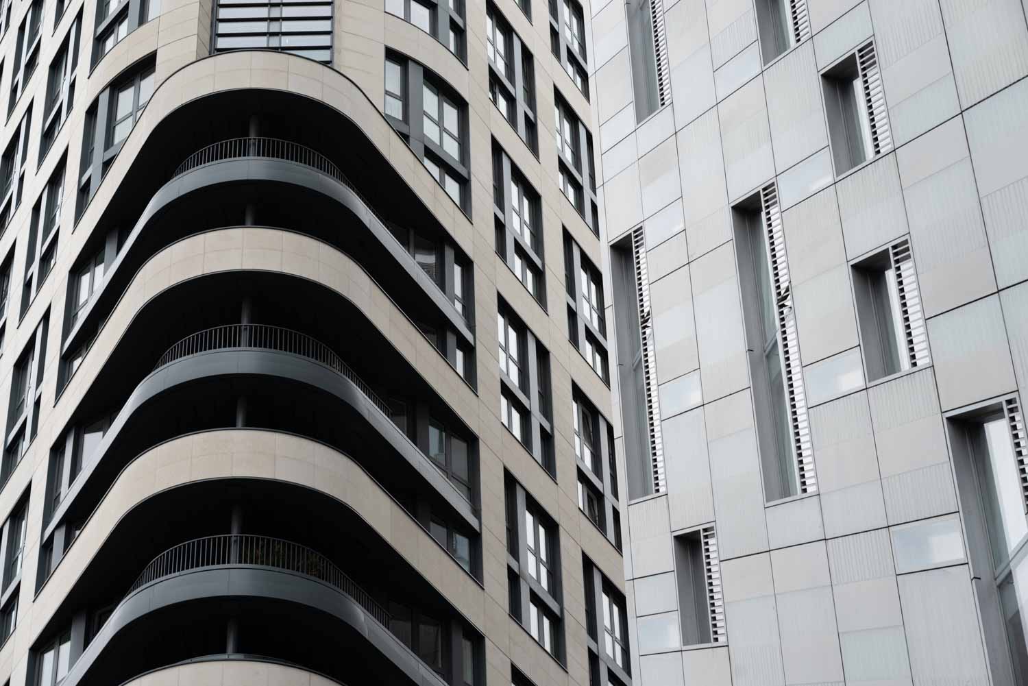 Curved balconies and stone facades of contemporary apartment buildings in Spitalfields, London